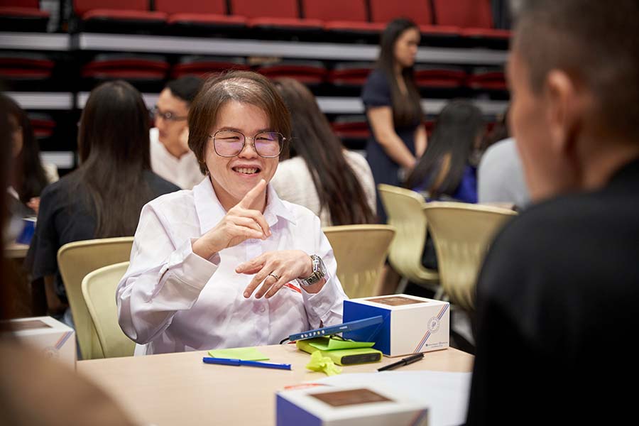 A participant sharing her opinion using the Singapore Sign Language through her interpreter (Credit: MCI / Kai Xuan Ng)