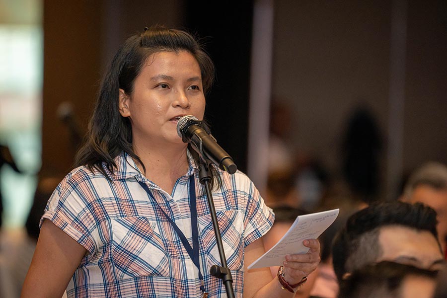 A member of the audience raising her questions during the Q&A segment of the dialogue.