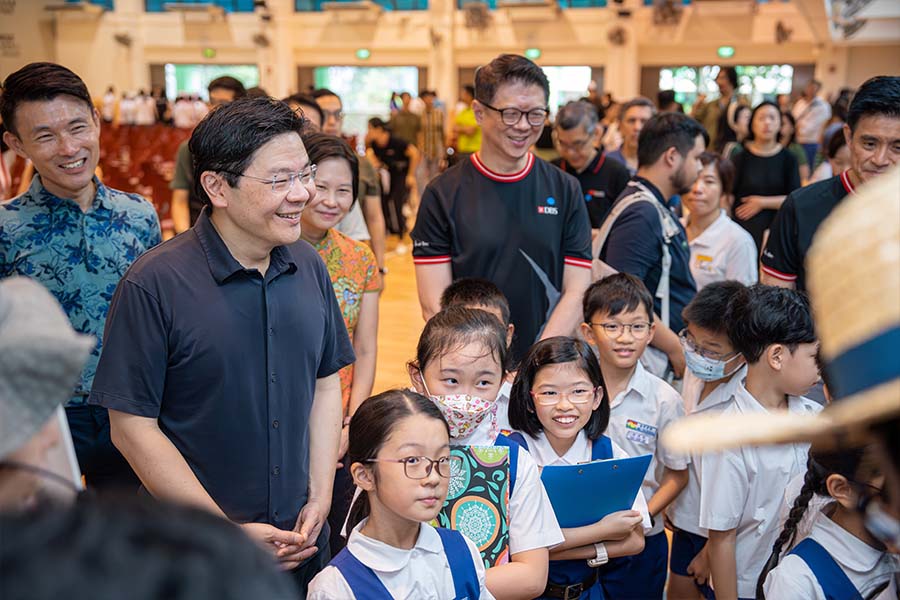 DPM Wong visiting the various booths set up by partners of the Go Green SG at Mee Too Primary School on 30 June 2023.