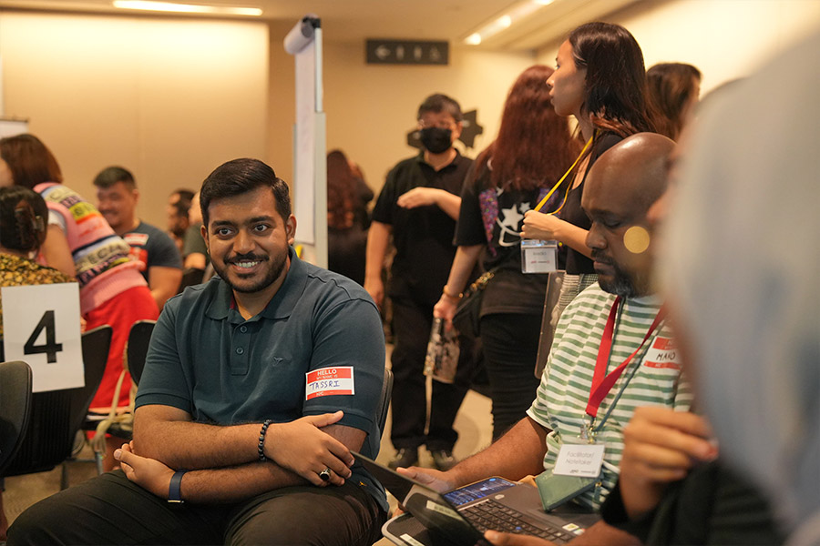 A participant engaging with his group in a breakout group discussion