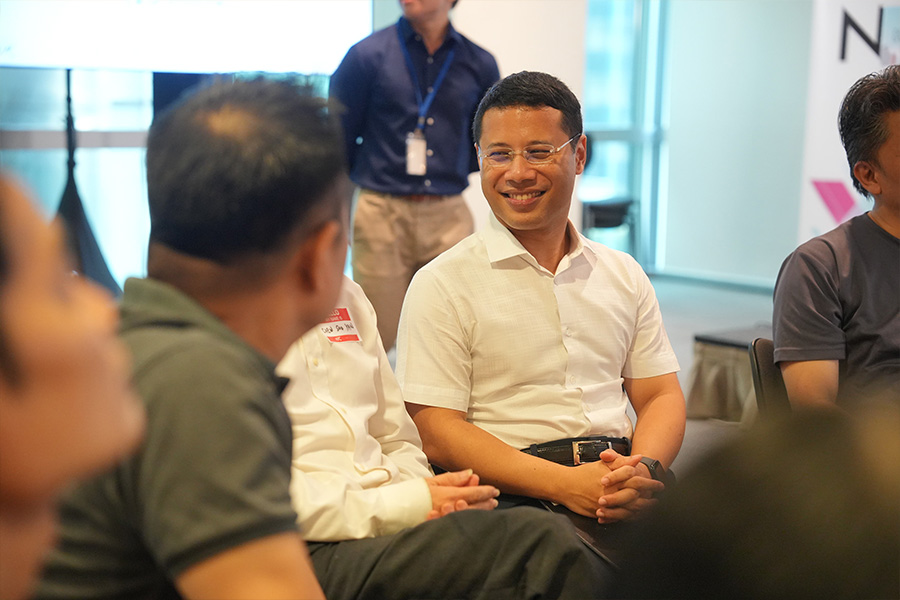 Minister Desmond Lee listening to a participant sharing his reflections during a group breakout discussion