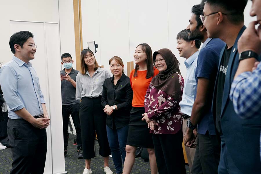DPM Lawrence Wong speaking to several social service practitioners on the sidelines of the Forward Singapore Conversation on 10 October 2022. (Credit: MCI / Ding Wei)