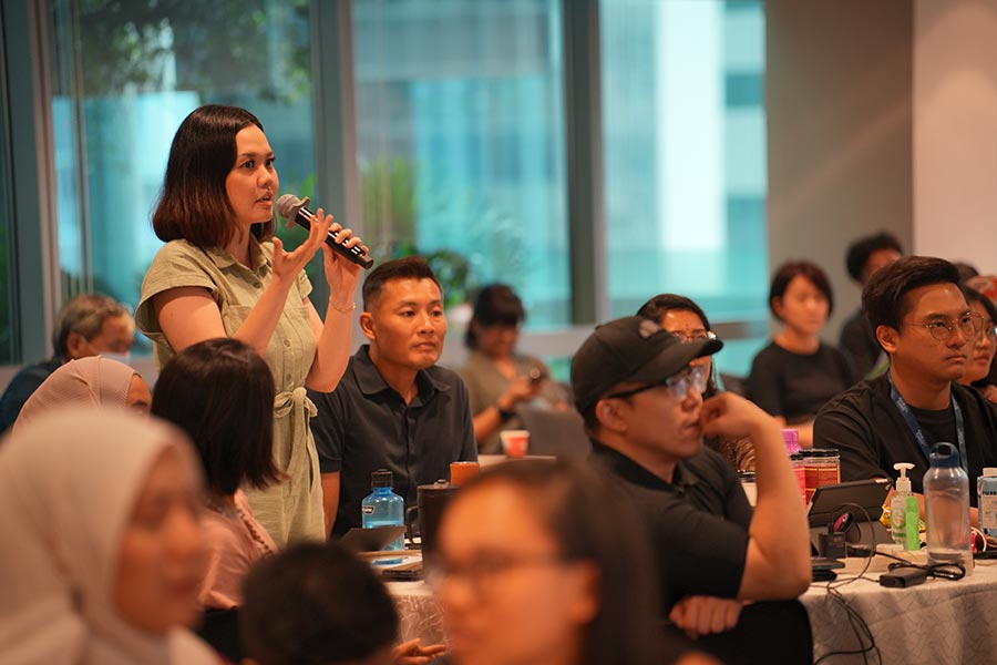 A youth leader posing a question to Minister Edwin Tong during the dialogue session at the event.  Credit: MCI / Dingwei Tan