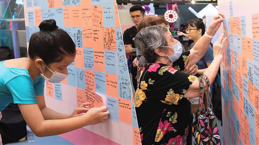 Members of the public placing post-its with their suggestions at the roadshow. (Credit: MCI / Syafiq) 