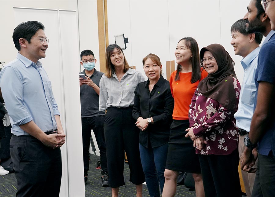 DPM Lawrence Wong speaking to several social service practitioners at the Forward Singapore Conversation.