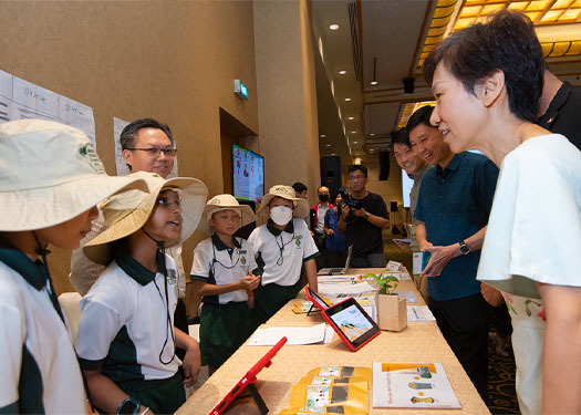Students from Xingnan Primary School sharing their environmental project with Minister Grace Fu.