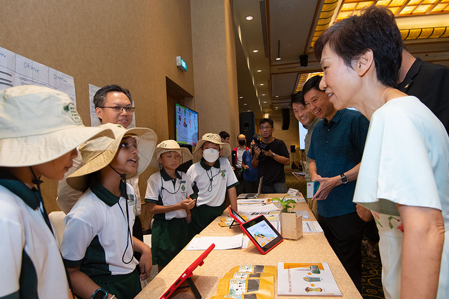 Students from Xingnan Primary School sharing their environmental project with Minister Grace Fu.